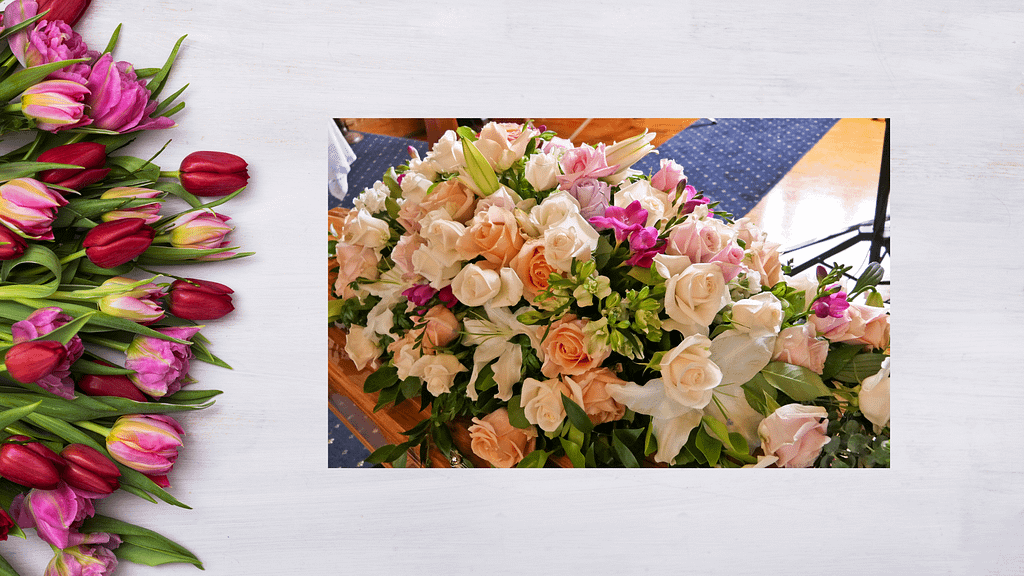 Funeral spray of ivory and pale pink roses