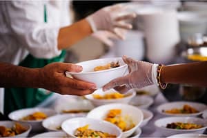 hands service food at a food bank