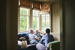 Elderly couple talking to a young man