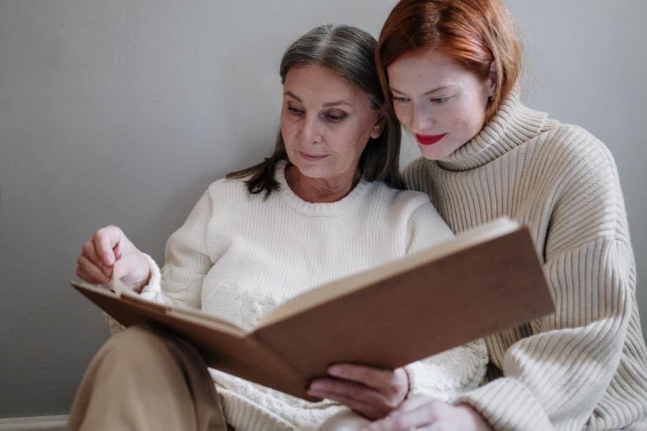 Two women looking at a photo album