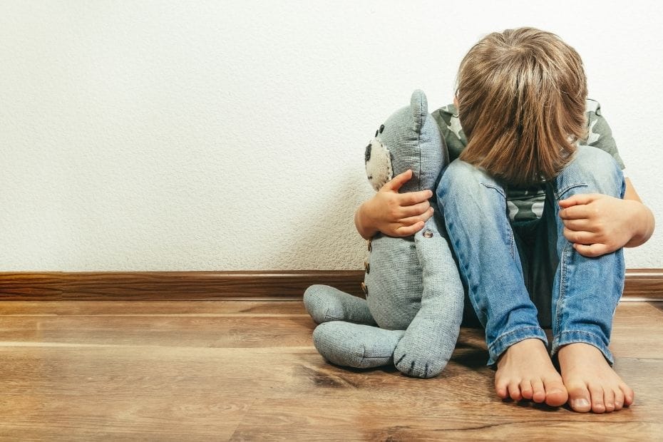 Sad child with teddy bear